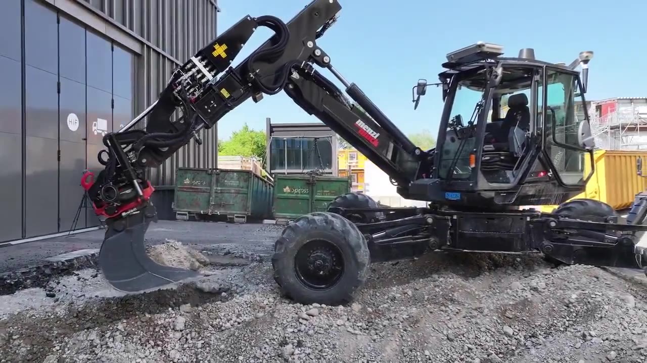 A close view of an excavator bucket engaging the ground and lifting material.